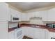 Well-maintained kitchen with white cabinets, modern appliances, and ample counter space at 93 Highway 81, Oxford, GA 30054