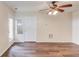A brightly lit living room with wood floors, and neutral colored walls at 93 Highway 81, Oxford, GA 30054