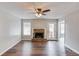 Cozy living room featuring wood floors, a fireplace, and a back patio door at 93 Highway 81, Oxford, GA 30054