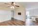 Bright living room with a ceiling fan, wood floors, and a television on the wall at 93 Highway 81, Oxford, GA 30054