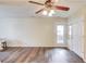 Bright living room with hardwood floors and a modern ceiling fan at 93 Highway 81, Oxford, GA 30054