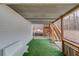 Outdoor patio with artificial grass, wood stairs, and bench seating creates a charming space at 93 Highway 81, Oxford, GA 30054