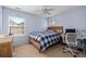 Modern bedroom with natural wood bed frame, desk and a light blue wall at 101 Oliver Ct, Douglasville, GA 30134