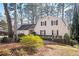 Tan house with dark shutters, attached garage, and landscaping at 1359 Ragley Hall Ne Rd, Brookhaven, GA 30319