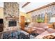 Living room with stone fireplace, wood beams, and area rug at 1359 Ragley Hall Ne Rd, Brookhaven, GA 30319