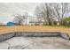 Large backyard with an empty patio and additional building at 1619 Ridgeview Nw Dr, Conyers, GA 30012