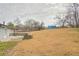 Expansive backyard showing a large grassy area and distant building at 1619 Ridgeview Nw Dr, Conyers, GA 30012