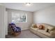 Bedroom with sofa and chair. Features neutral paint and carpet. Natural light from the window at 1619 Ridgeview Nw Dr, Conyers, GA 30012