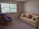 Comfortable bedroom featuring a large window with a view and a cozy seating area at 1619 Ridgeview Nw Dr, Conyers, GA 30012