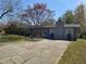 Traditional single story home with brick chimney, small front yard and long driveway at 1619 Ridgeview Nw Dr, Conyers, GA 30012