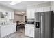 Well-lit kitchen featuring white cabinets, stainless steel appliances, and a view into the adjacent dining area at 1619 Ridgeview Nw Dr, Conyers, GA 30012