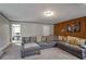 Inviting living room featuring a sectional sofa, wood paneling, and neutral color palette at 1619 Ridgeview Nw Dr, Conyers, GA 30012