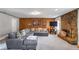 Well-lit living room showcasing a stone fireplace, wood paneling, and comfortable seating at 1619 Ridgeview Nw Dr, Conyers, GA 30012