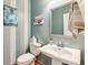 Stylish powder room with a pedestal sink and gray-blue walls at 4240 Hunters Walk Way, Cumming, GA 30028