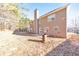 A private backyard offers a serene escape with mature trees and a patio area at 8270 Mossybrook Ln, Douglasville, GA 30135