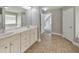 Bathroom featuring a double vanity and neutral-toned tile flooring at 8270 Mossybrook Ln, Douglasville, GA 30135