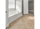 Bathroom with a white bathtub and patterned tile flooring at 8270 Mossybrook Ln, Douglasville, GA 30135