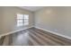 Bedroom featuring hardwood floors, a window with blinds, and neutral paint at 8270 Mossybrook Ln, Douglasville, GA 30135