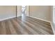 Spacious bedroom with hardwood floors and a view to the upstairs hallway and staircase at 8270 Mossybrook Ln, Douglasville, GA 30135