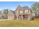 Attractive two-story home featuring a stone foundation, covered entrance, and attached garage at 8270 Mossybrook Ln, Douglasville, GA 30135