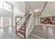 Grand foyer with staircase, high ceilings, and views into the living and kitchen areas at 8270 Mossybrook Ln, Douglasville, GA 30135