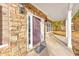 Close-up of a stone front porch with a welcome mat at 8270 Mossybrook Ln, Douglasville, GA 30135