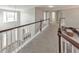 Upstairs hallway with staircase and view to the kitchen and backyard at 8270 Mossybrook Ln, Douglasville, GA 30135