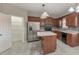 Kitchen boasts stainless steel appliances, island with seating, tile floors and ample cabinet space at 8270 Mossybrook Ln, Douglasville, GA 30135