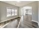 Open-concept living room featuring hardwood floors, large windows, and an arched doorway at 8270 Mossybrook Ln, Douglasville, GA 30135