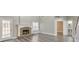Bright living room with a fireplace, hardwood floors, and access to the backyard at 8270 Mossybrook Ln, Douglasville, GA 30135