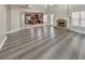 Expansive living room with a fireplace, hardwood floors, and an open view of the kitchen at 8270 Mossybrook Ln, Douglasville, GA 30135