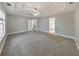 Open main bedroom features a trey ceiling, carpeted floors, neutral paint and a view to the bathroom at 8270 Mossybrook Ln, Douglasville, GA 30135