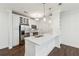 Modern white kitchen with stainless steel appliances and an island at 901 Abernathy Ne Rd # 3200, Atlanta, GA 30328