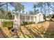 Large backyard with a screened porch, white fence, and plenty of green space at 3495 Habersham Nw Rd, Atlanta, GA 30305
