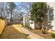 Spacious backyard with a stone walkway, mature trees, and partial fencing at 3495 Habersham Nw Rd, Atlanta, GA 30305