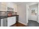 Charming butler pantry with wine fridge, granite countertops, and custom glass storage at 3495 Habersham Nw Rd, Atlanta, GA 30305