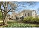 Charming one-story home featuring a bright yellow front door and shuttered windows surrounded by mature landscaping at 3495 Habersham Nw Rd, Atlanta, GA 30305