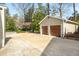 Detached two-car garage with tan siding and a large driveway at 3495 Habersham Nw Rd, Atlanta, GA 30305