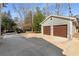 Two-car garage with brown doors and concrete driveway at 3495 Habersham Nw Rd, Atlanta, GA 30305