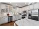 Modern kitchen featuring white cabinets, stainless steel appliances, and marble countertops at 3495 Habersham Nw Rd, Atlanta, GA 30305