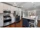 Well-lit kitchen with stainless steel appliances, a center island with seating, and hardwood floors at 3495 Habersham Nw Rd, Atlanta, GA 30305