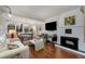Open-concept living room featuring a fireplace, hardwood floors, and lots of natural light at 3495 Habersham Nw Rd, Atlanta, GA 30305