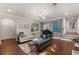Spacious living room with a grand piano, hardwood floors, and large windows at 3495 Habersham Nw Rd, Atlanta, GA 30305