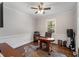 Bright office features hardwood floors, a decorative rug, and a ceiling fan at 3495 Habersham Nw Rd, Atlanta, GA 30305