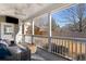 Outdoor porch featuring ceiling fans and comfortable seating, offering serene views of backyard at 3495 Habersham Nw Rd, Atlanta, GA 30305