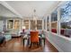 Bright sunroom with large windows, wood floors, stylish furnishings, and access to the porch at 3495 Habersham Nw Rd, Atlanta, GA 30305