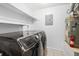 Bright laundry room with washer, dryer, and shelving at 73 Rumson Se Ct, Smyrna, GA 30080