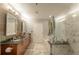 Modern bathroom with double sinks, soaking tub, and glass shower at 1080 Peachtree Ne St # 2710, Atlanta, GA 30309