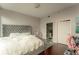 Main bedroom with tufted headboard and hardwood floors at 1080 Peachtree Ne St # 2710, Atlanta, GA 30309