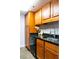 Modern kitchen with wood cabinets, granite counters and stainless steel appliances at 1280 W Peachtree Nw St # 2813, Atlanta, GA 30309